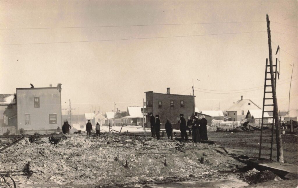 Burned buildings and residents after the January 1914 Trout Creek Michigan fire.