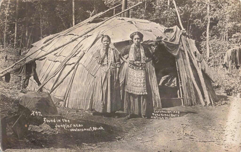 Ojibwa women and child outside lodge near Watersmeet Michigan in 1908.