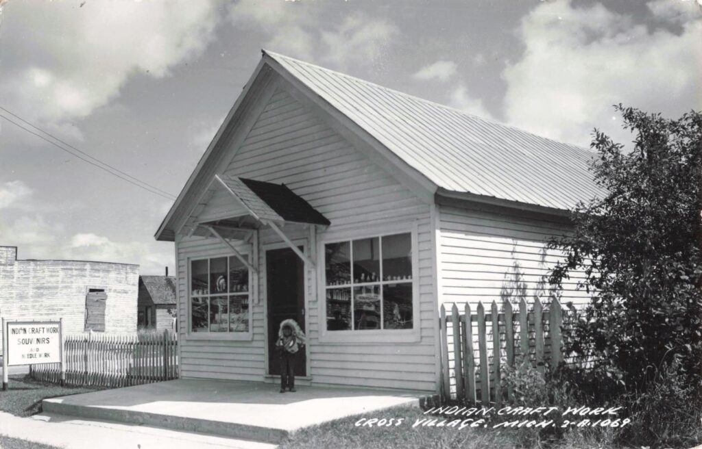 Historic craft shop postcard in Cross Village, Michigan, advertising Indian craft work, souvenirs and needlework.
