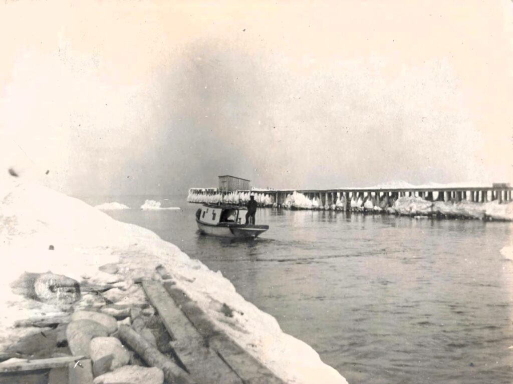 Tug fishing in winter by Leland Pier/Dock