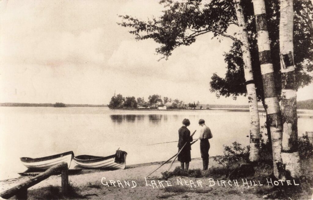 Two people by a lake shore.