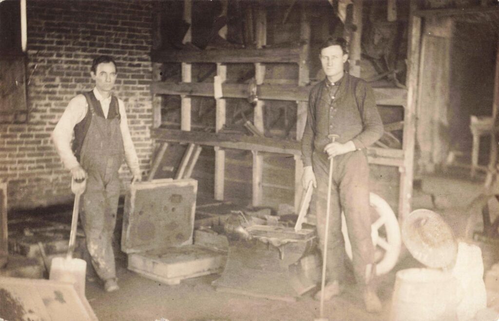 Workers working on molding for foundry works.