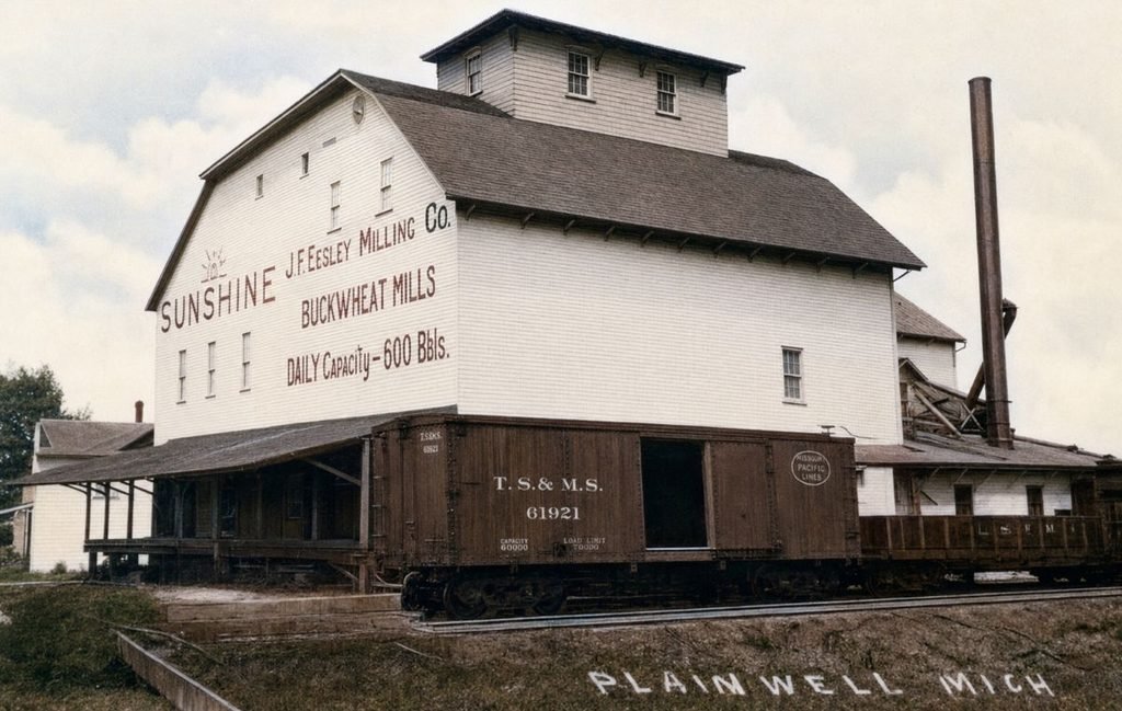 Historic mill with train car nearby
