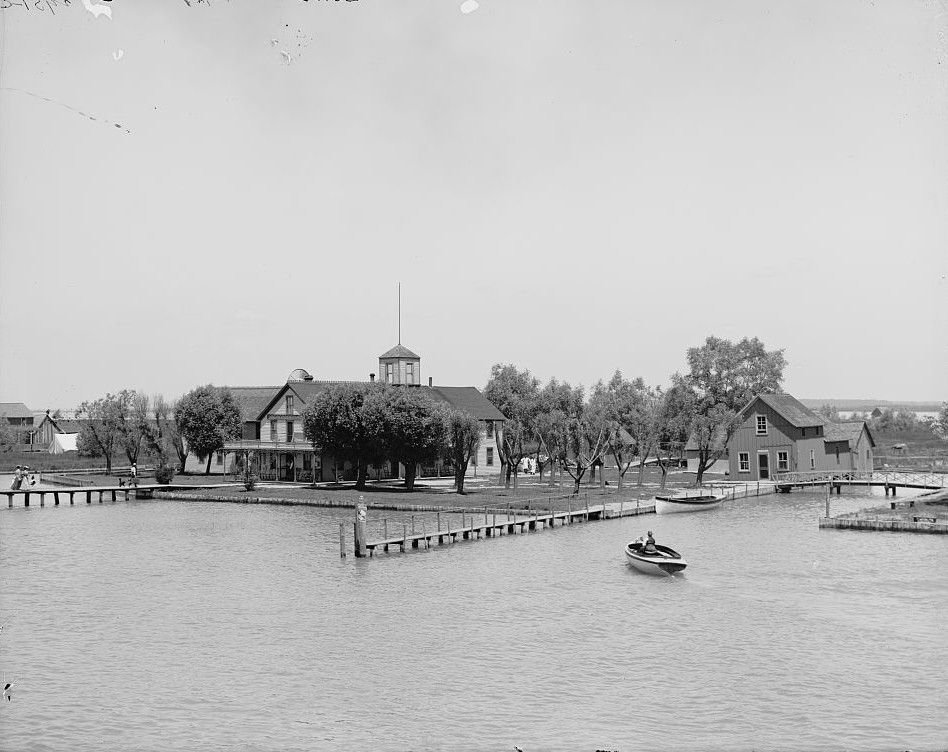 Joe Bedore's Hotel, shown about 1905, had a broad porch, orchard trees and long docks built for guests arriving by boat.