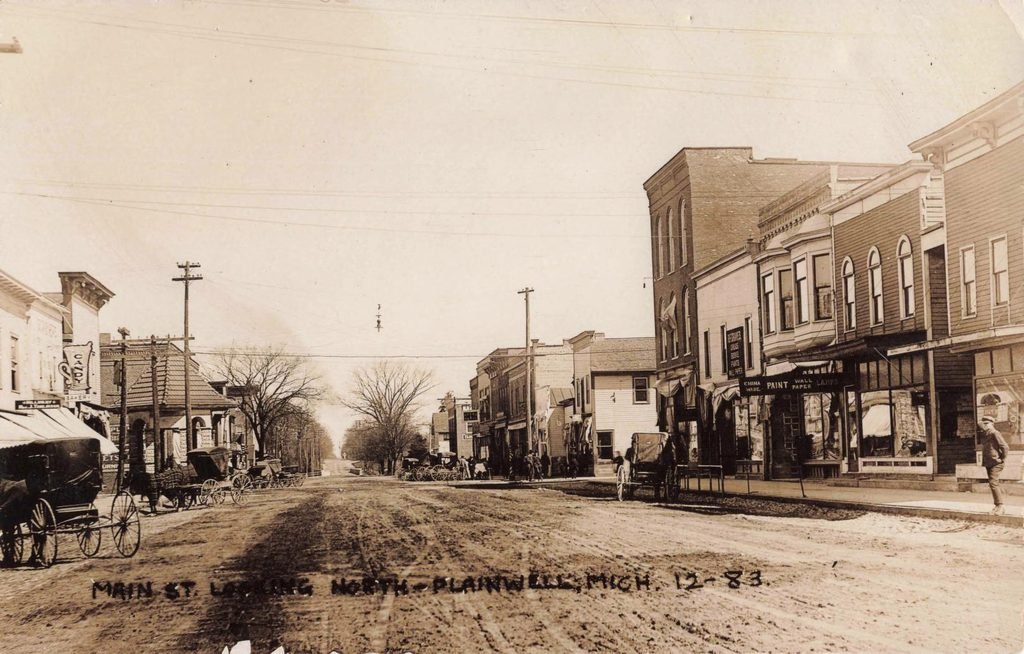 Historic street scene with buildings and carriages.- History of Plainwell Michigan 