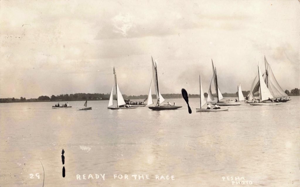 Sailboats gather for a race in the St. Clair Flats, where organized water sport became part of the summer club calendar.