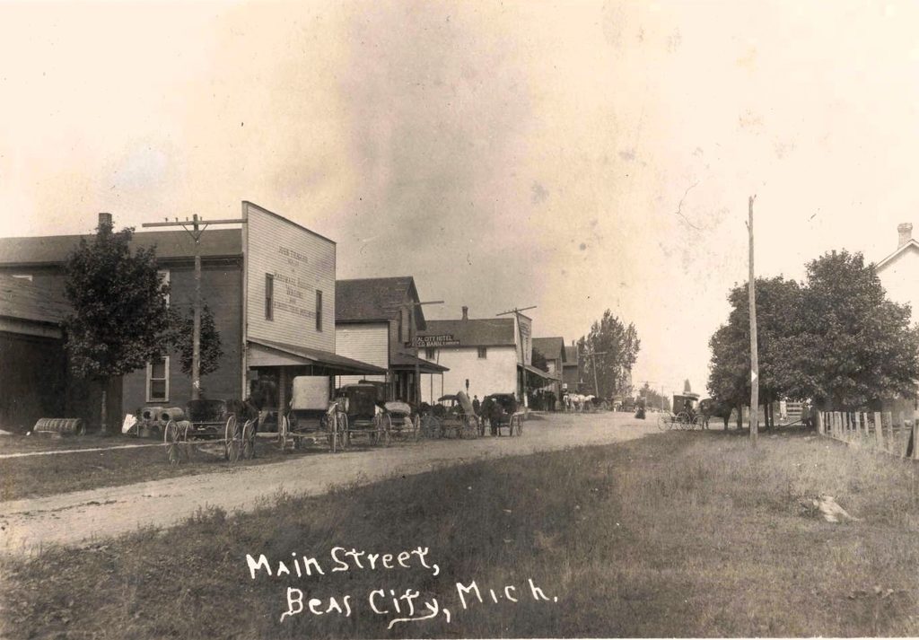 Historic street with horse-drawn carriages.