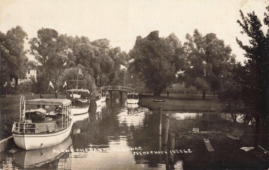 Historic boats on a tranquil canal.