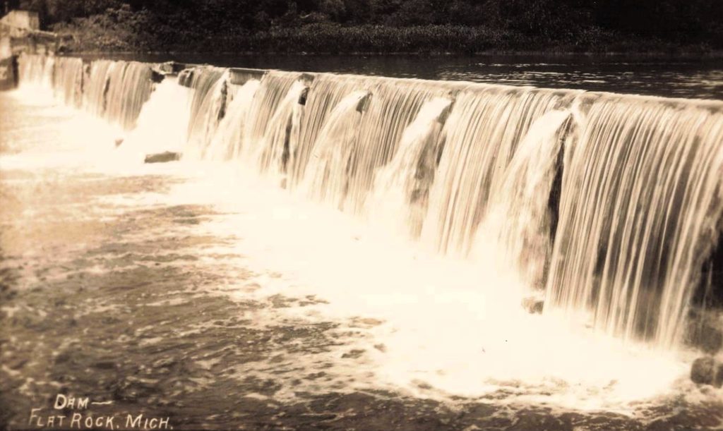 Waterfall cascading over a dam.
