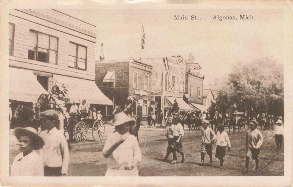 Historic street scene with horse-drawn carriages.