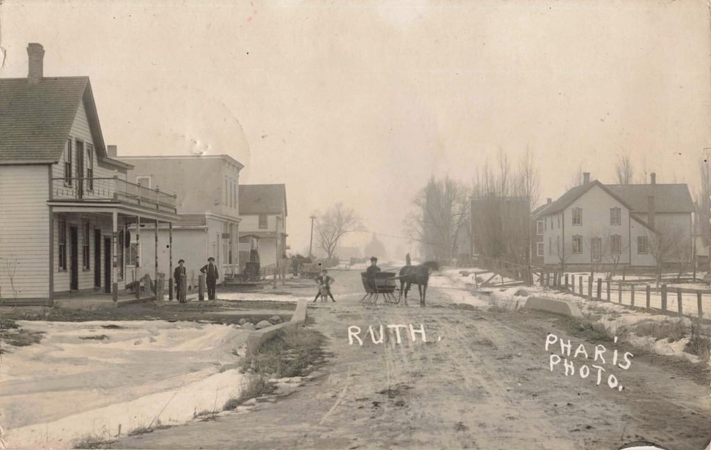 Early 1900s winter street scene in Ruth Michigan with horse drawn sleigh and stores - Ruth Michigan History