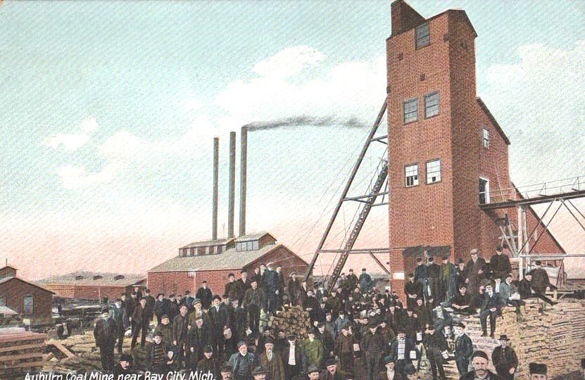Historic coal mine with workers gathered