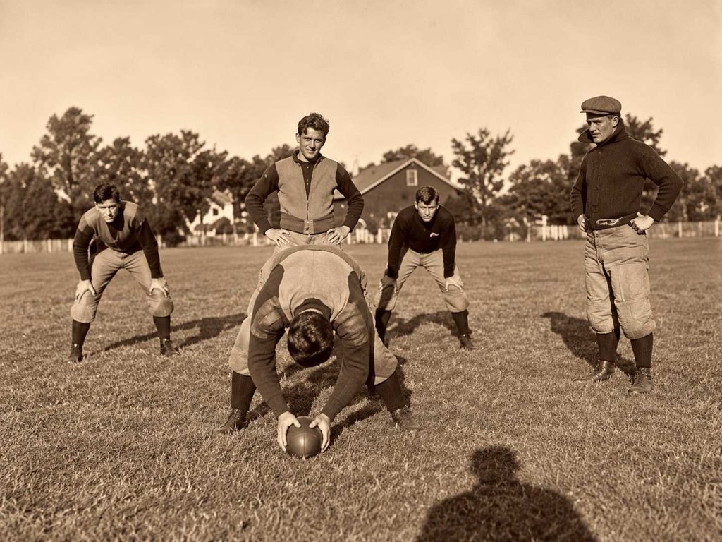 Restored photo of Fielding Yost, with players at Whitmore Lake trainging camp [Yost at right, Tom Hammond on left, "Germany" Schulz(?) centering ball } Date: 1904