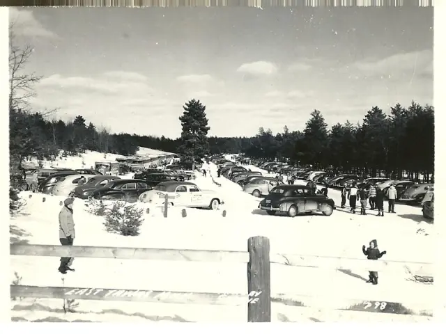 Snowy parking lot filled with cars