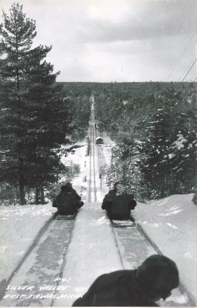 Sledding down a snowy hill.