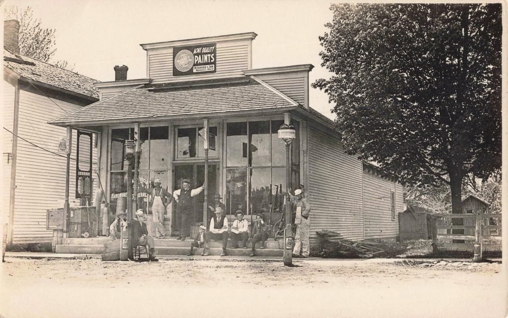 Historic paint store with people outside.