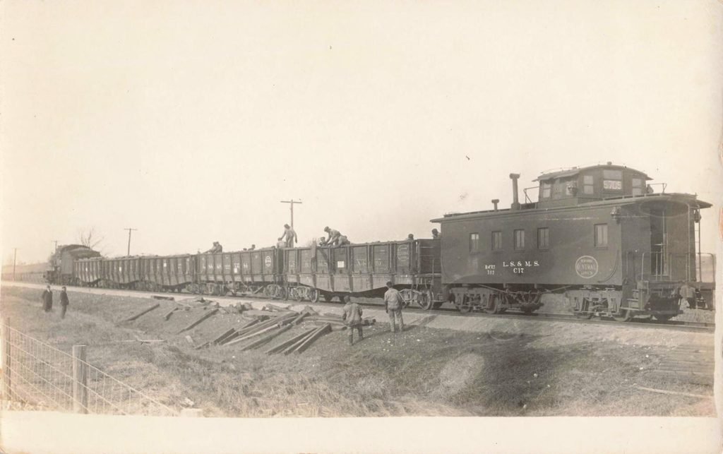 Old train with freight cars, workers.