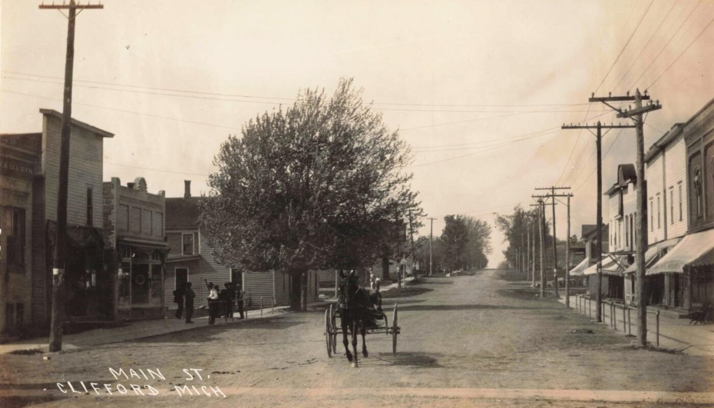 Historic street scene with horse-drawn carriage.