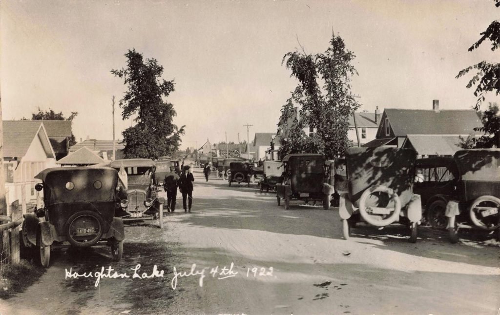 History of Houghton Lake Village Michigan street crowded with automobiles on July 4 1923