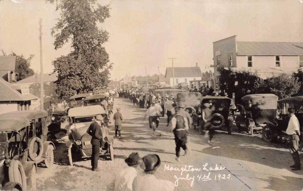 Automobiles parked along village street for the July 4th holiday.