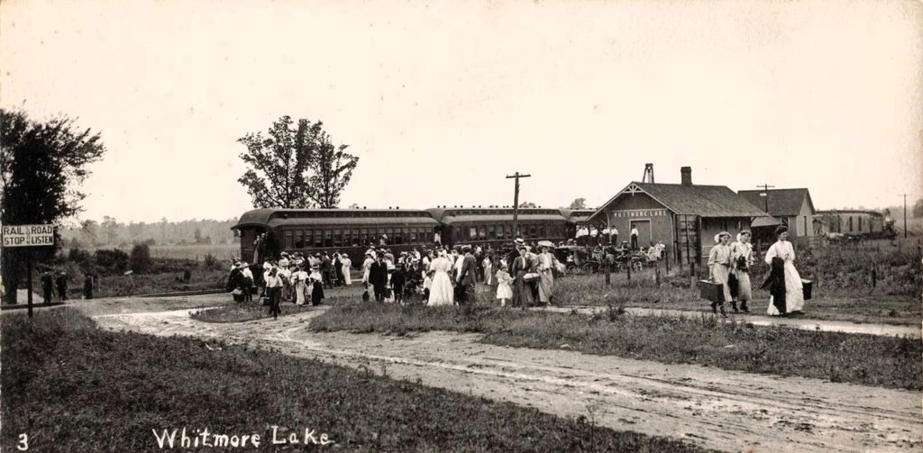 Passengers Step off the train at Whitmore Lake for a week of lakeside rest.